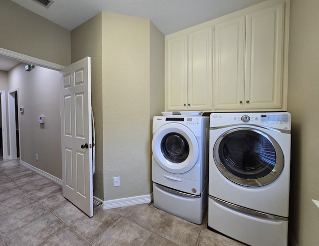 4808 W Cherrywood Ct W, Midland, TX 79707 - laundry area featuring cabinet space, washing machine and dryer, light tile patterned floors, and baseboards