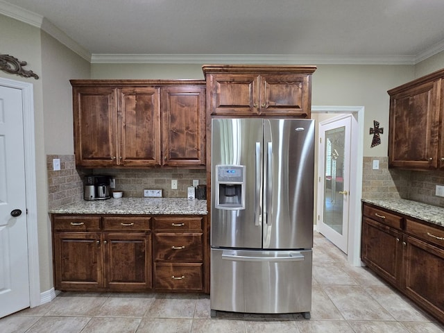 4808 W Cherrywood Ct W, Midland, TX 79707 - kitchen featuring stainless steel refrigerator with ice dispenser, tasteful backsplash, ornamental molding, light stone counters, and dark brown cabinetry
