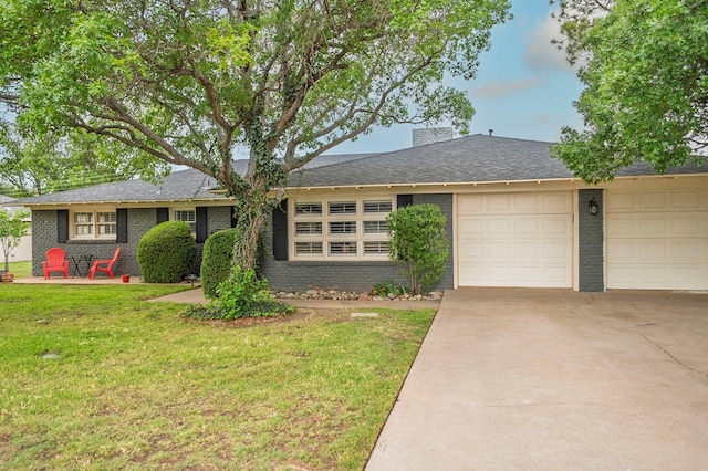 2607 N N St, Midland, TX 79705 - ranch-style house featuring brick siding, a garage, a front yard, a chimney, and concrete driveway