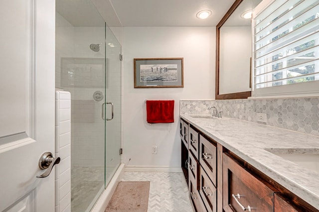 2607 N N St, Midland, TX 79705 - full bath featuring double vanity, decorative backsplash, a stall shower, a sink, and baseboards
