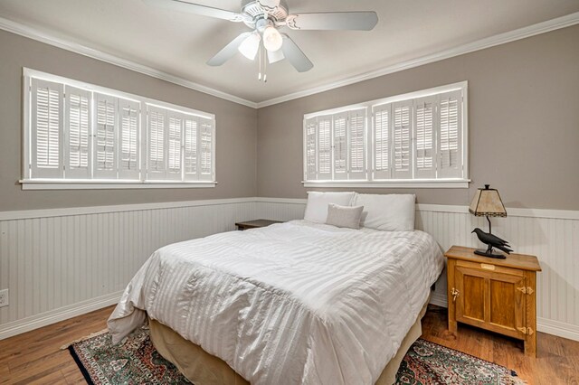 2607 N N St, Midland, TX 79705 - bedroom with ceiling fan, a wainscoted wall, ornamental molding, and wood finished floors