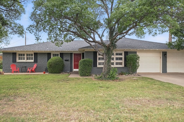 2607 N N St, Midland, TX 79705 - ranch-style home with a front lawn, roof with shingles, brick siding, an attached garage, and driveway