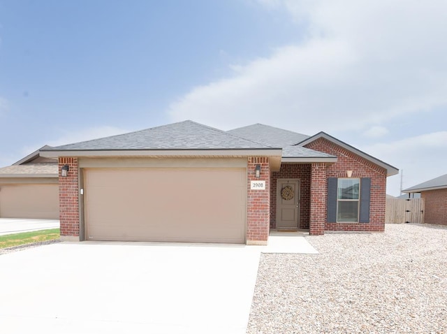 2908 Stagecoach Ct, Midland, TX 79705 - ranch-style home with brick siding, driveway, an attached garage, and a shingled roof