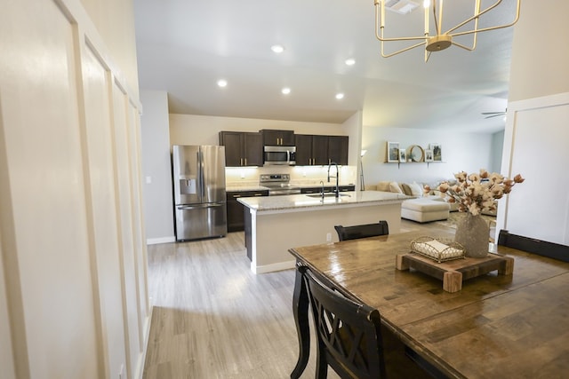 2908 Stagecoach Ct, Midland, TX 79705 - dining room with light wood-type flooring, a chandelier, and recessed lighting
