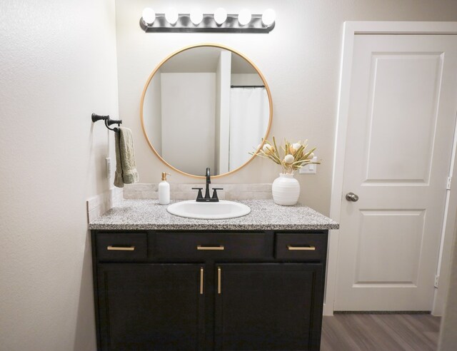 2908 Stagecoach Ct, Midland, TX 79705 - bathroom with vanity and wood finished floors
