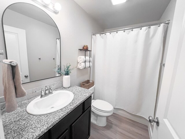 2908 Stagecoach Ct, Midland, TX 79705 - bathroom with vanity, wood finished floors, and a shower with shower curtain