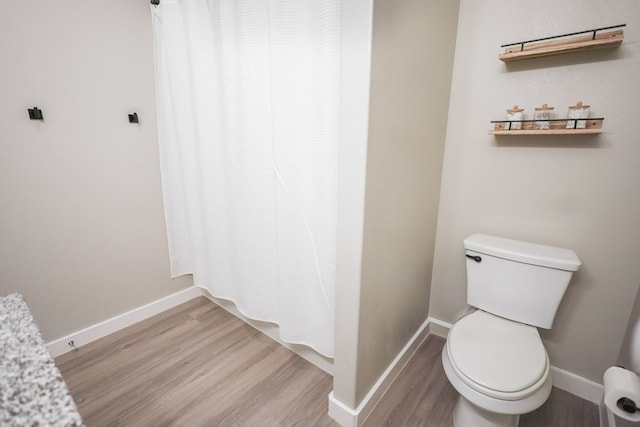 2908 Stagecoach Ct, Midland, TX 79705 - bathroom with wood finished floors and curtained shower