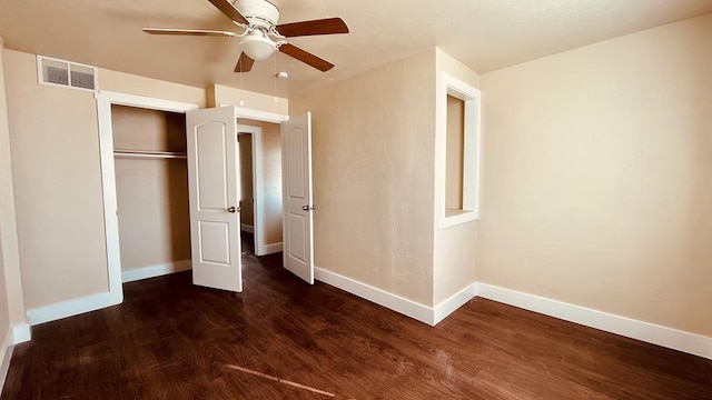 unfurnished bedroom with ceiling fan, a closet, and dark wood-type flooring