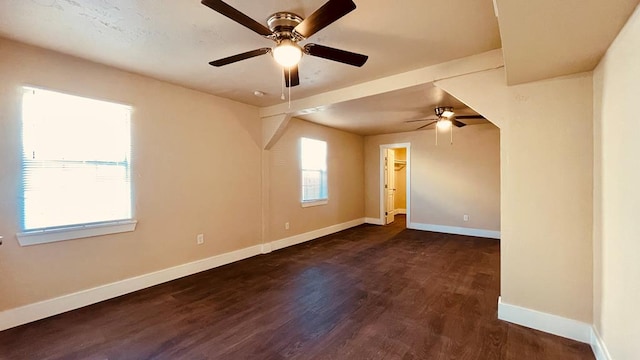 unfurnished room with dark hardwood / wood-style floors and ceiling fan