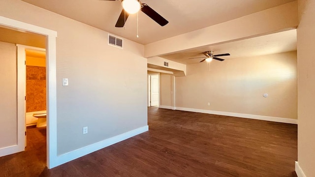 spare room featuring ceiling fan and dark wood-type flooring