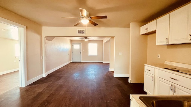 kitchen featuring white cabinets, dark hardwood / wood-style flooring, ceiling fan, and sink