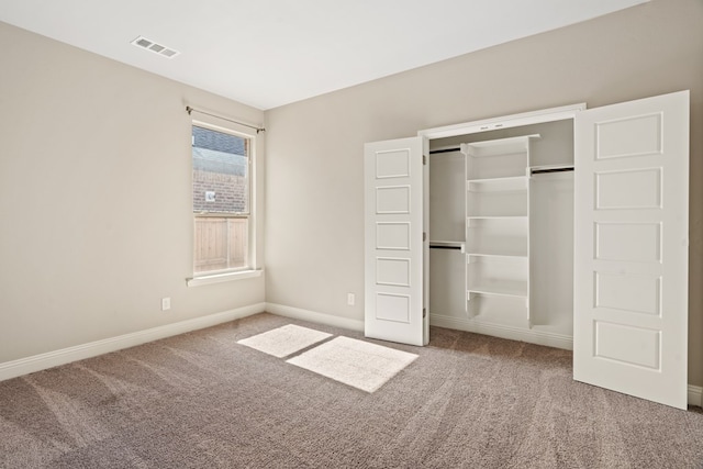 unfurnished bedroom featuring carpet flooring and a closet