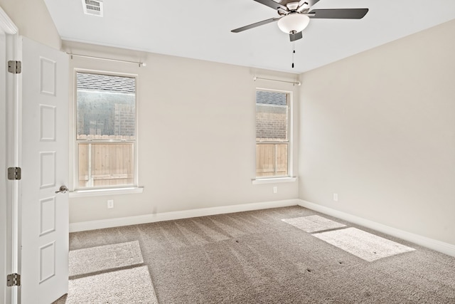 spare room with carpet floors, ceiling fan, and a healthy amount of sunlight