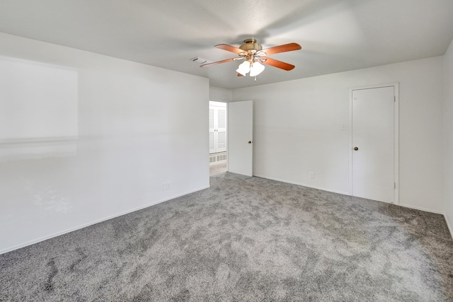 carpeted empty room featuring ceiling fan