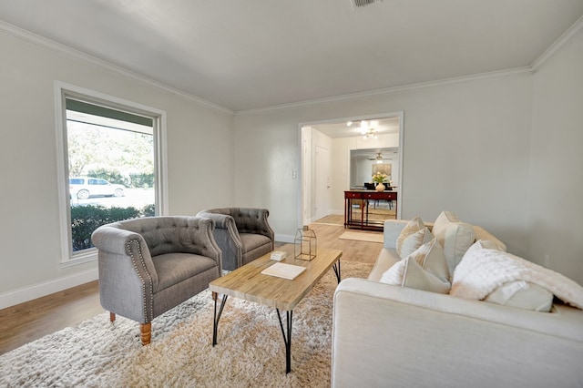 living room with ceiling fan, light hardwood / wood-style floors, and crown molding