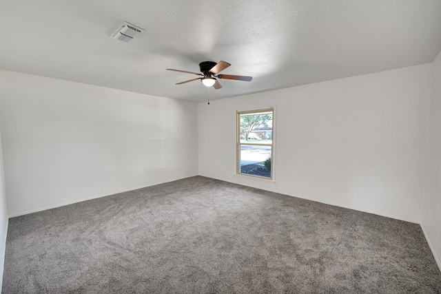 carpeted empty room featuring a textured ceiling and ceiling fan