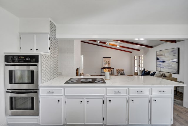 kitchen with lofted ceiling with beams, double oven, kitchen peninsula, wood-type flooring, and black electric stovetop