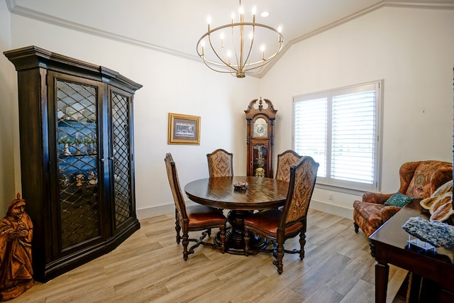 dining space featuring ornamental molding, light wood-type flooring, and lofted ceiling