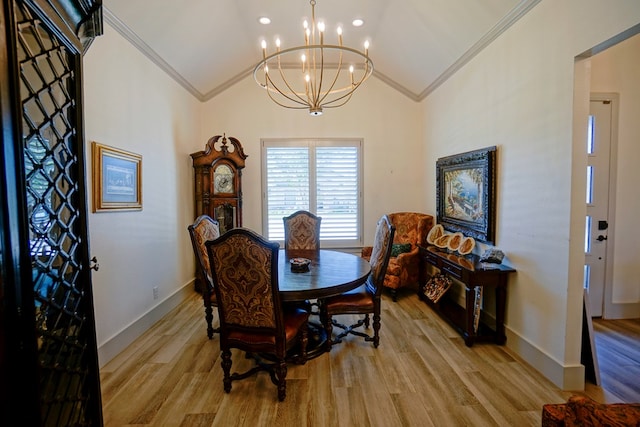 dining space featuring light hardwood / wood-style floors, vaulted ceiling, and ornamental molding