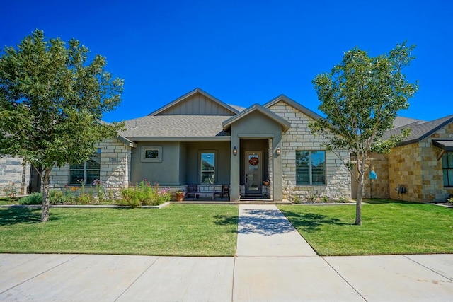 view of front of home with covered porch and a front lawn