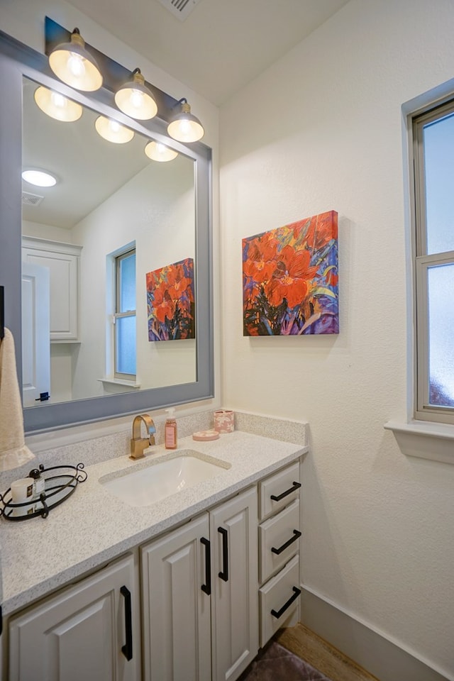 bathroom with plenty of natural light and vanity