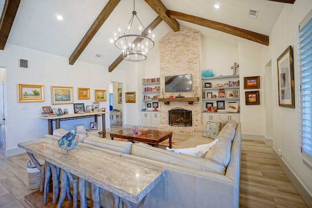 living room with high vaulted ceiling, a stone fireplace, built in shelves, light wood-type flooring, and beam ceiling