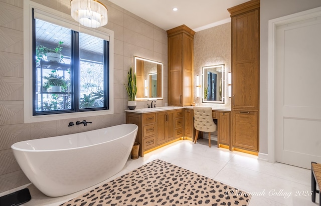 bathroom with tile patterned floors, vanity, tile walls, and a tub