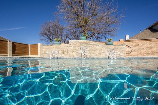 view of patio / terrace featuring pool water feature and a fenced in pool