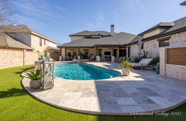 view of swimming pool featuring pool water feature and a patio area