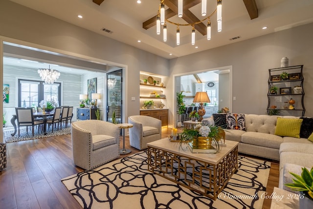 living room featuring an inviting chandelier, wood-type flooring, coffered ceiling, and beamed ceiling