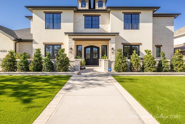 view of front facade with french doors and a front lawn