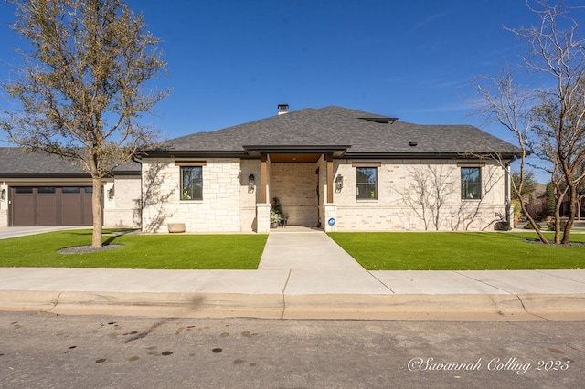 view of front facade with a garage and a front lawn