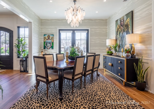 dining space featuring an inviting chandelier, ornamental molding, and dark hardwood / wood-style floors