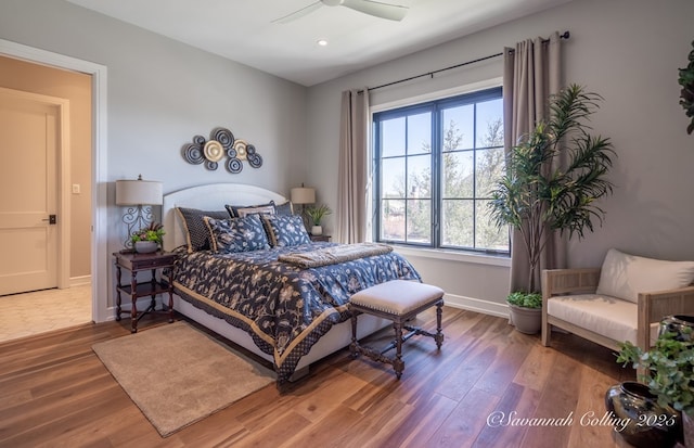 bedroom with hardwood / wood-style floors and ceiling fan