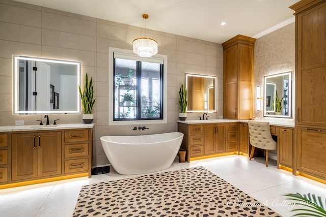 bathroom with vanity, tile walls, tile patterned floors, and a tub to relax in