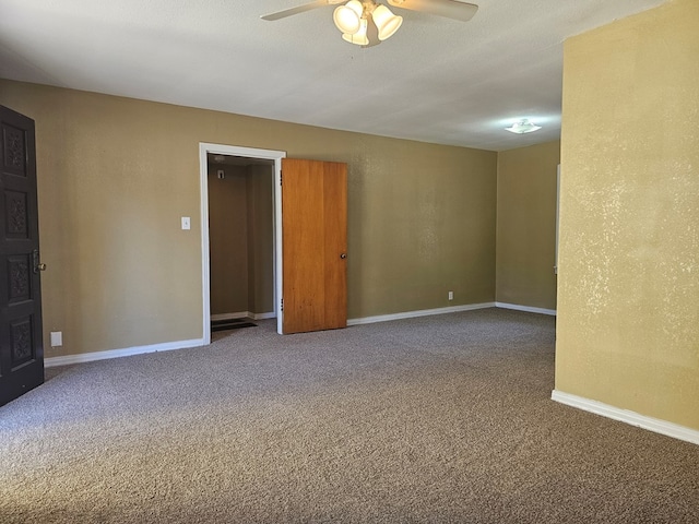 empty room featuring carpet, ceiling fan, and a textured ceiling