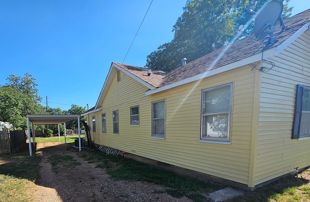 view of home's exterior featuring central AC and a carport