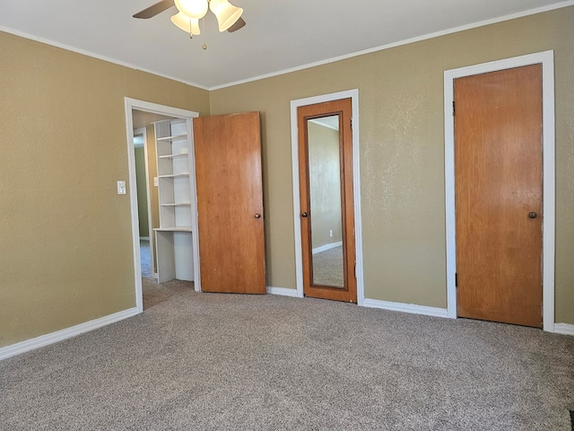 unfurnished bedroom featuring ceiling fan, carpet floors, and ornamental molding