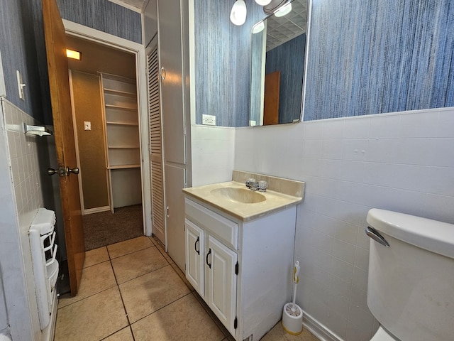 bathroom with tile patterned flooring, vanity, and toilet