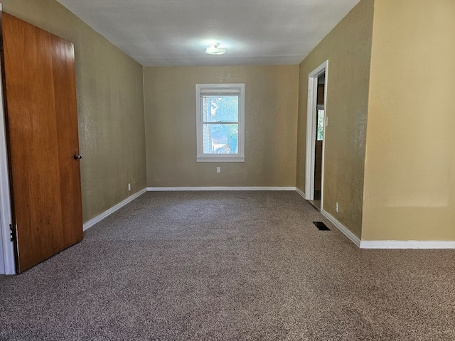 spare room with carpet flooring and a textured ceiling