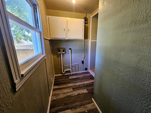 clothes washing area featuring cabinets, hookup for a washing machine, and dark wood-type flooring