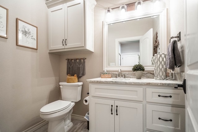 bathroom featuring hardwood / wood-style floors, vanity, and toilet