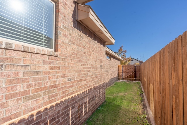 view of side of home featuring a lawn