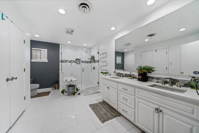 bathroom featuring tile patterned floors, a shower with door, vanity, and toilet