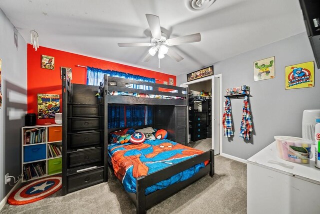 carpeted bedroom featuring ceiling fan and a closet