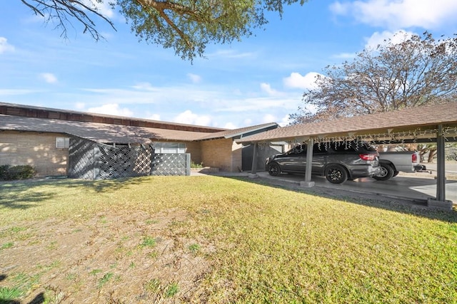 view of side of home featuring a lawn and a carport