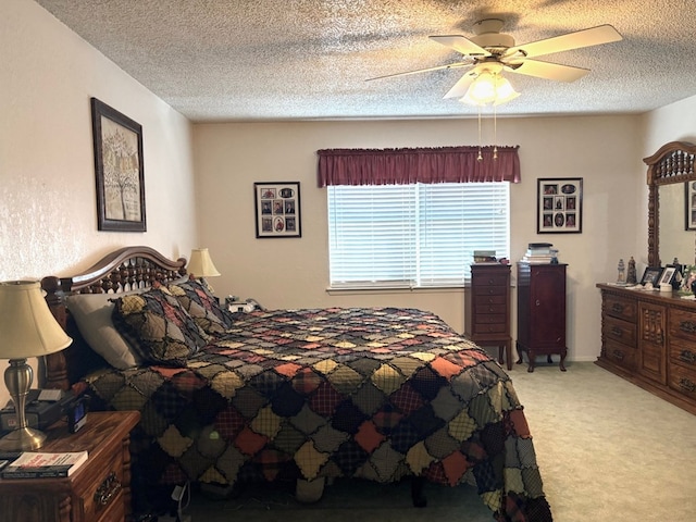 bedroom featuring ceiling fan, carpet flooring, and a textured ceiling