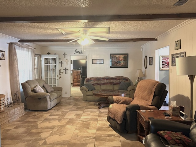 living room featuring visible vents, beam ceiling, ornamental molding, ceiling fan, and a textured ceiling