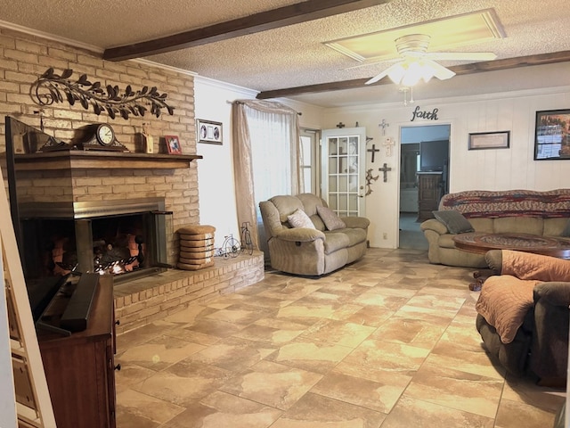 living area with a brick fireplace, crown molding, ceiling fan, beam ceiling, and a textured ceiling