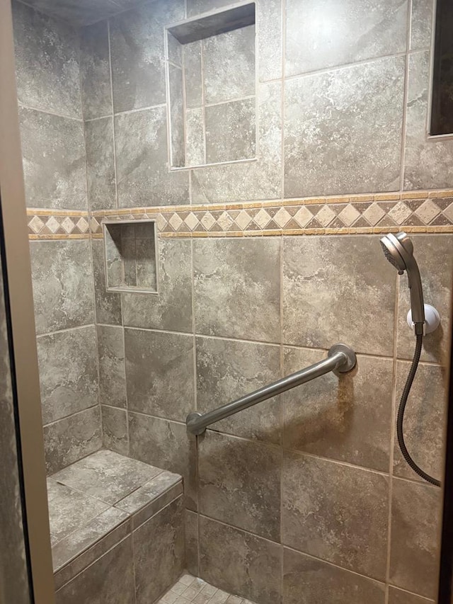 full bath featuring a tile shower